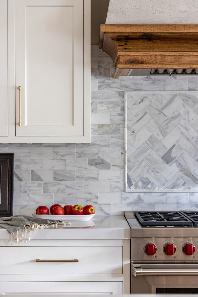 Features. Photo of white kitchen with red details.